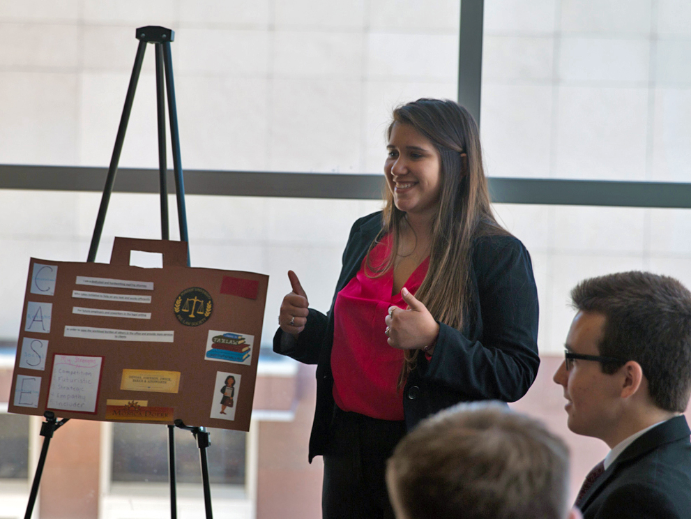 A student gives the thumbs up after giving her presentation in Rawls Hall