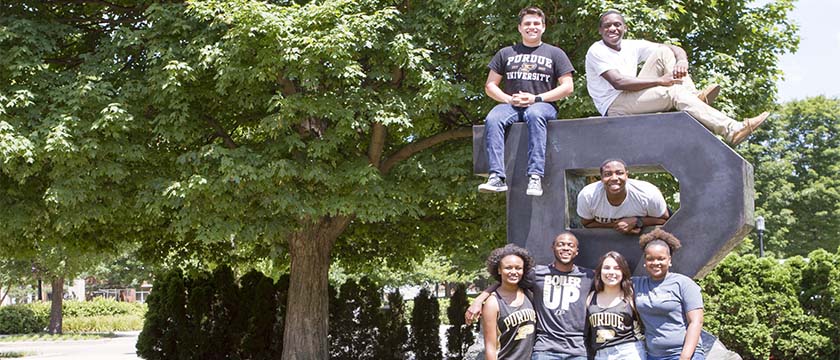 Group of students at unfinished Purdue logo