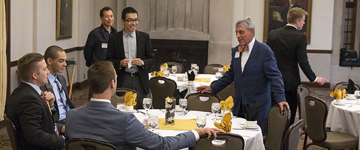 Howard Berkowitz chats with students at the student managed investment fund luncheon